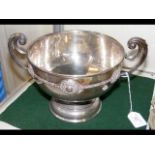A two handled silver bowl with Celtic style raised