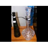 A silver mounted cut glass decanter with stopper,