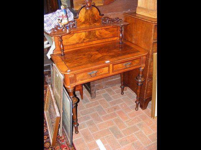 A Victorian two drawer writing desk with cross ban