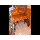 A Victorian two drawer writing desk with cross ban