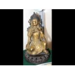 An 18th century buddha with gilt finish seated on