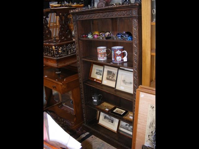 A carved oak bookcase with five shelves - width 87