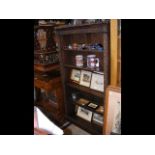 A carved oak bookcase with five shelves - width 87