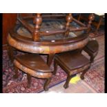 An oriental oval table with carved scene below gla