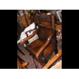 A Wainscot style oak chair with panelled back rest