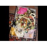 A box of costume jewellery including necklaces, br