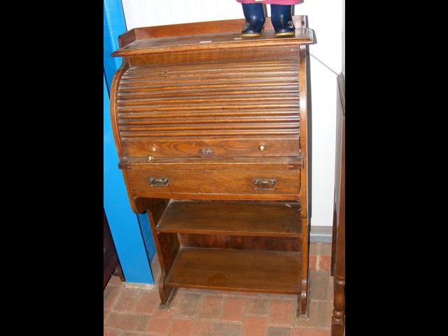 An oak roll top bureau