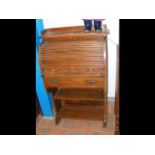 An oak roll top bureau