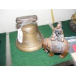 An old cow bell together with figure on elephant