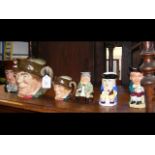 A collection of character jugs, including Royal Do