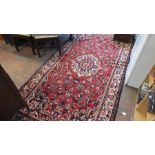 A Middle style carpet with red ground and geometri