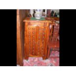 A hardwood cabinet enclosed by a pair of studded d