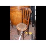 A 19th century correction chair with spindle back