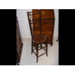 A 19th century correction chair with turned back