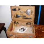 A leather vanity case containing silver topped bot