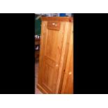 A panelled pine cupboard