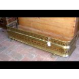 A Victorian pierced brass fender - width 95cms