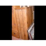 An old two door pine storage cupboard