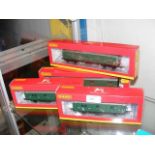 Four boxed Hornby brake vans etc