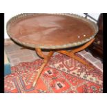 A circular coffee table with copper tray top - dia