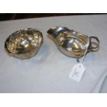 A silver sauceboat with scroll handle together wit