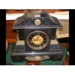 A decorative Victorian slate mantel clock with vis