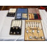 A set of six cased miniature silver spoons, a case