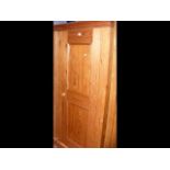 A panelled pine cupboard