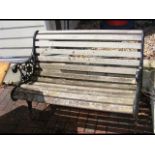 A cast iron garden bench with wooden slats