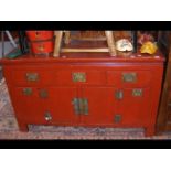 A Chinese red lacquered side cabinet with four dra