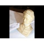 A carved hard stone miniature bust - height 6.5cms