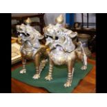 A pair of brass Chinese Dogs of Fo, one damaged -