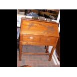 An Oriental carved teak bureau with two drawers un