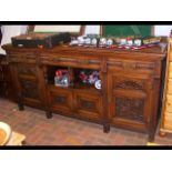 A carved Edwardian mahogany sideboard with three d
