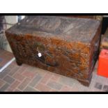 A Chinese carved camphorwood chest, top depicting