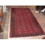 A Middle Eastern rug with red ground and geometric