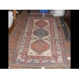 An antique Middle Eastern rug with geometric borde