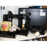 A vintage Singer sewing machine - 222K - with carr