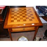 A mahogany side table with single drawer and chequ