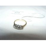 A three stone diamond ring in gold setting