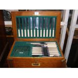 A 1920's canteen of cutlery in fitted oak case