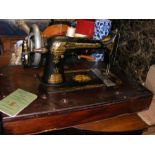 A Singer sewing machine in mahogany case