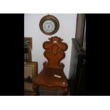 A Victorian carved oak hall chair with cabriole le