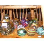 A collection of glass paperweights including green