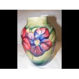 An 18cm high Moorcroft pottery vase with floral de