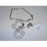 A silver chain link necklace with magnetic clasp t