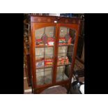 An Art Nouveau style two door display cabinet