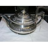 A silver Regency teapot with gadroon body and silv