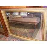 A large gilt bevelled wall mirror - 115cm x 142cm
