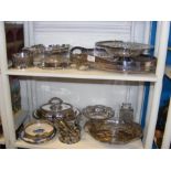 Two shelves of plated ware, including table salts,